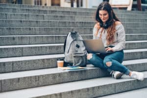 university student on steps at school