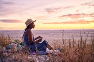 woman writing by the sea