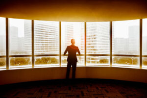 businessman looking out office windows