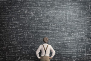 man thinking at empty blackboard