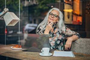 older freelance writer at cafe