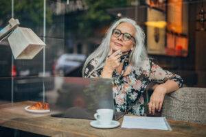 older freelance writer at cafe