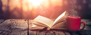 open book and coffee on table