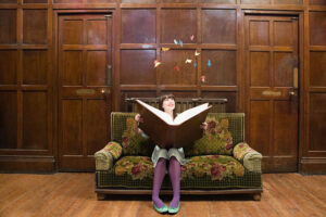 teenage girl reading big fantasy book