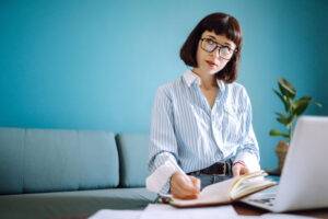 woman at home writing