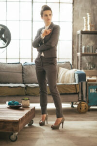 career woman in suit standing in loft