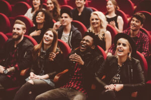 group laughing in theater seats