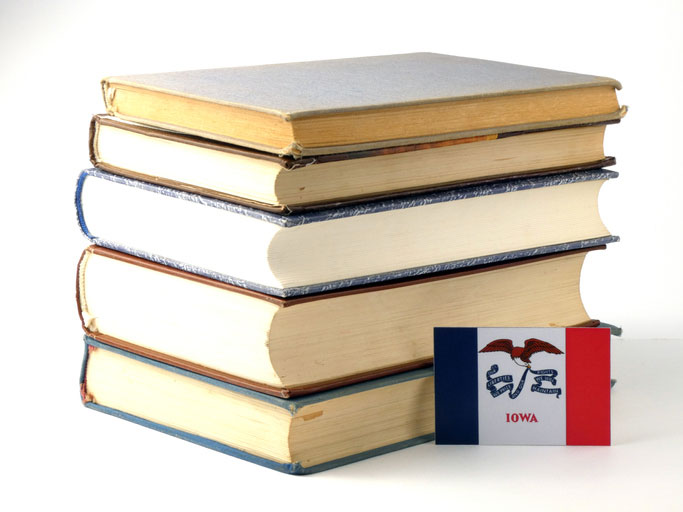 iowa flag by a stack of books