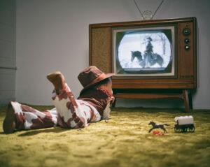 little cowboy watching westerns on the tv