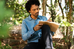 Man writing ideas in notebook