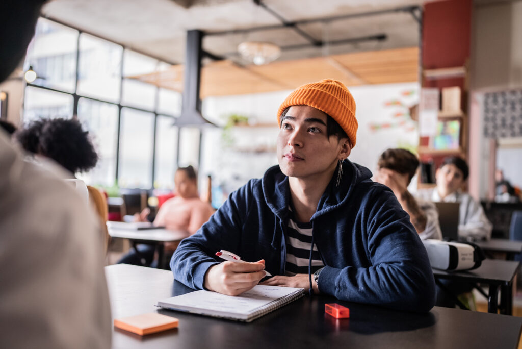 Male college student listening intently to a lecture.