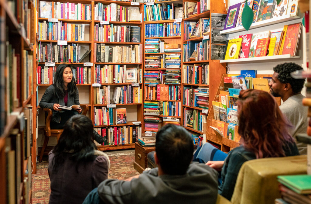 People talking in a book group meeting inside a bookstore